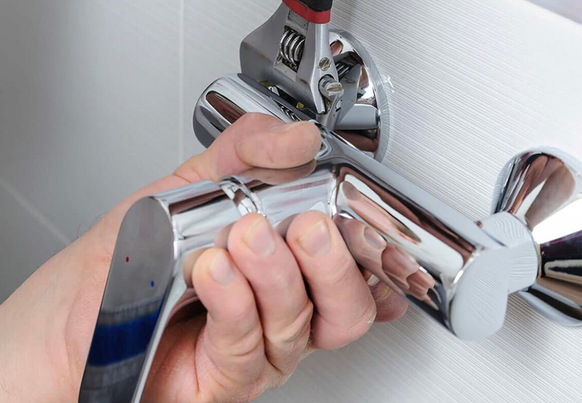Hand Holding The Faucet — Leak Detection Services in Darwin, NT